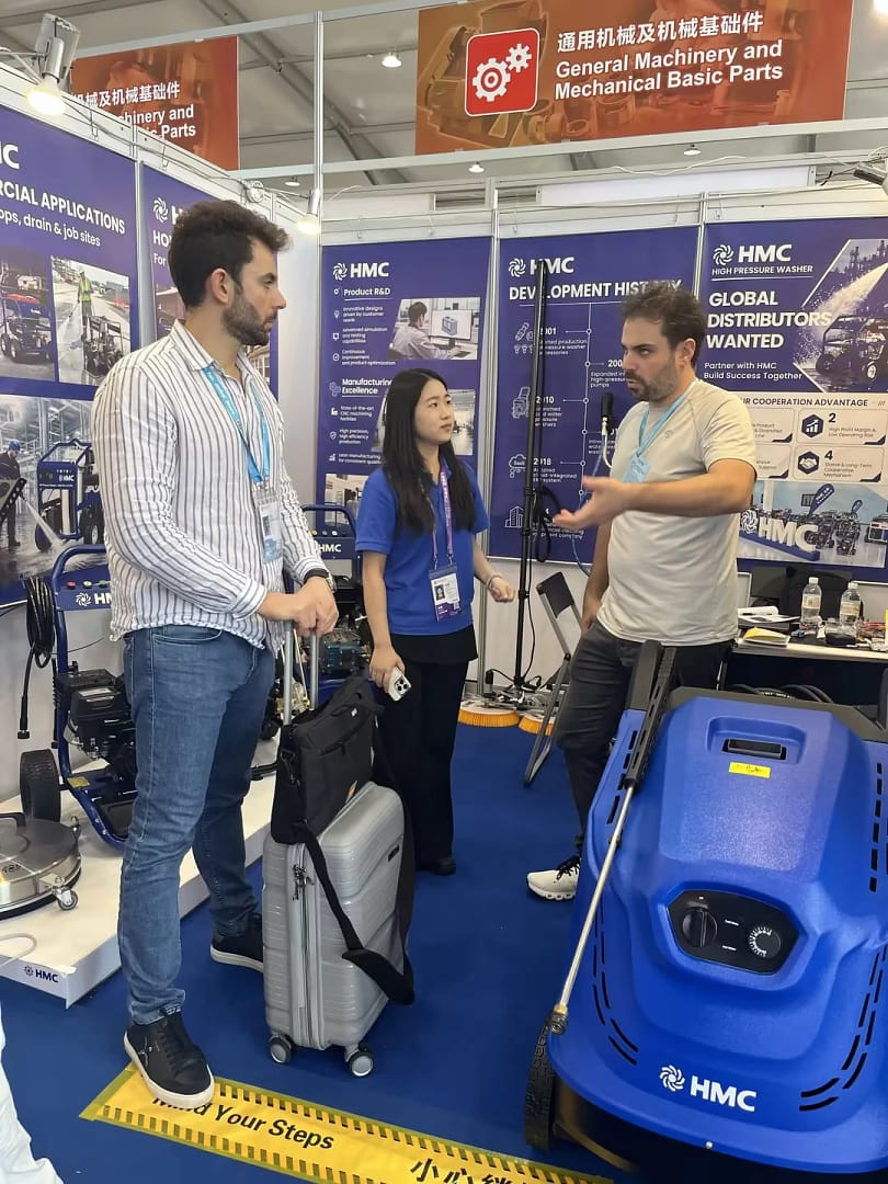 Discussing professional cleaning equipment with visitors.